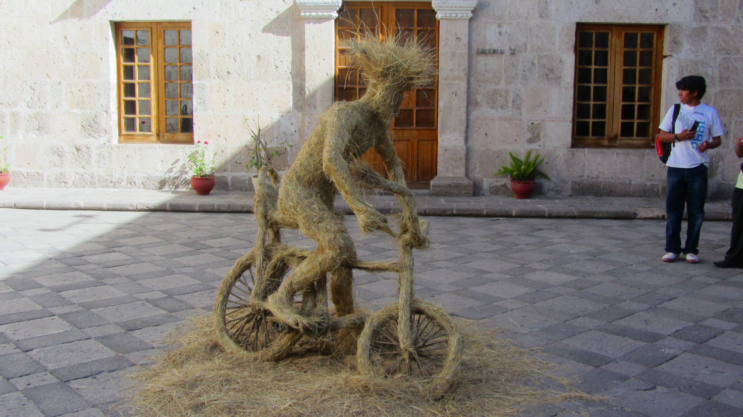 Bicycle rider close the entrance of the convent Santa Catalina in Arequipa